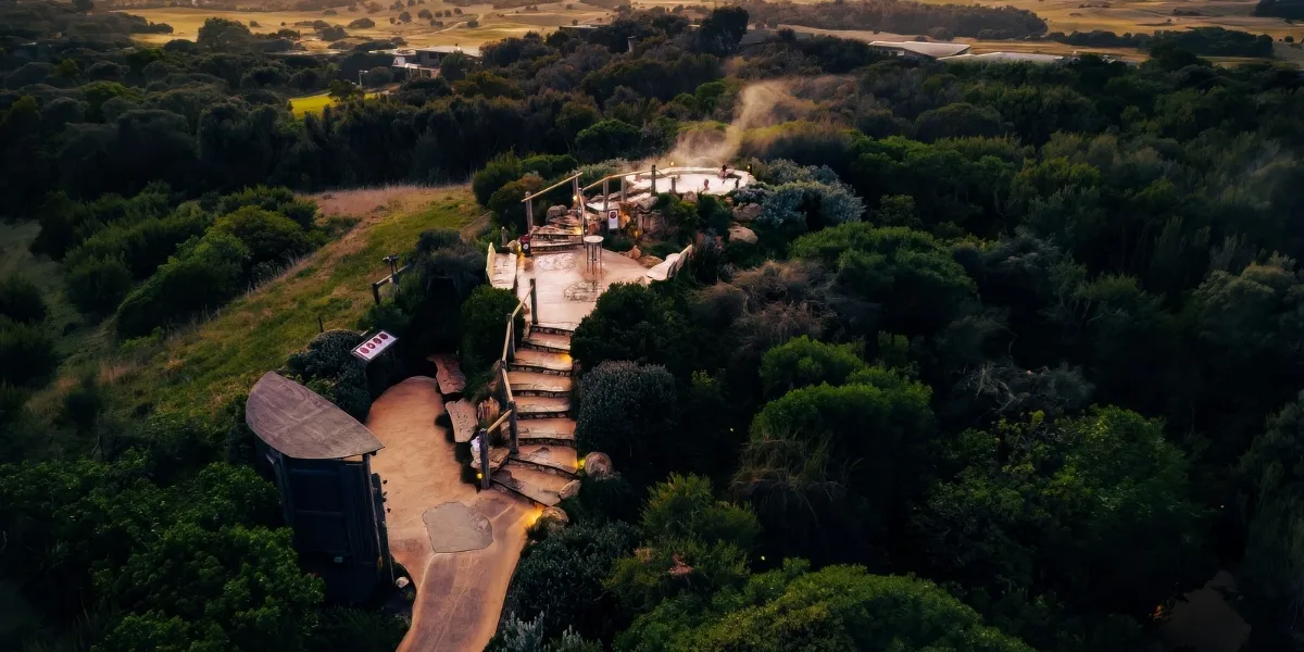 Steaming hot spring pools on a hillside at Mornington Peninsula Hot Springs