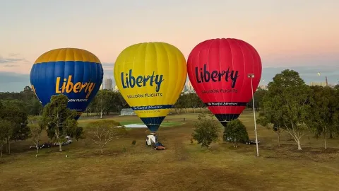 Balloons drifting over Melbourne at sunrise