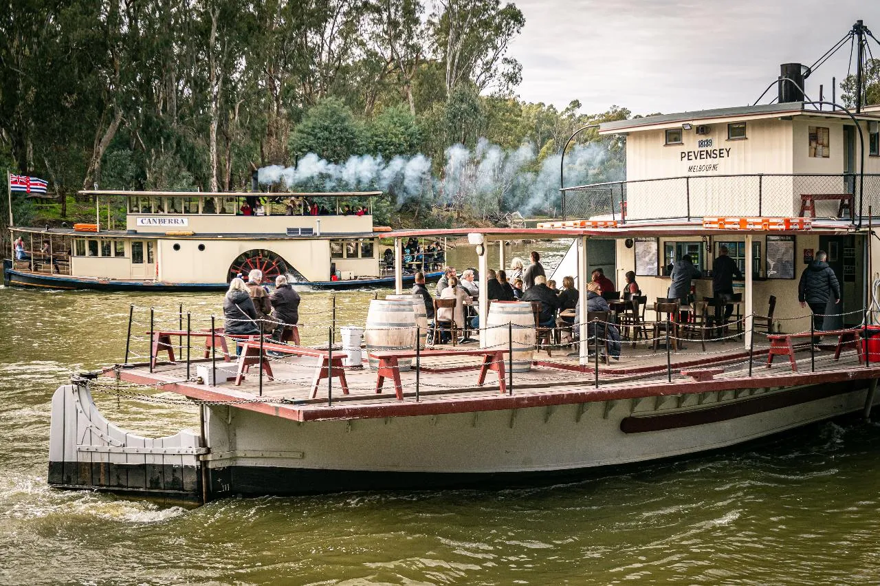 Cruise boats travelling along a scenic Victorian river